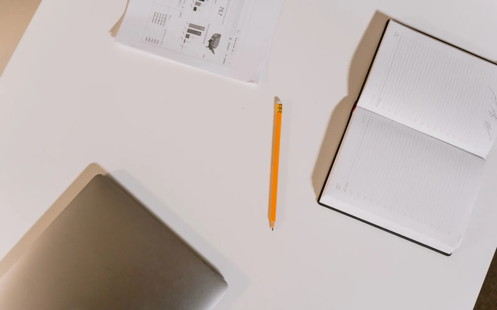 Glossaire ouvert et stylo posés sur un bureau en bois